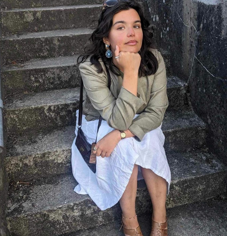 A photo of Liz sitting on some steps