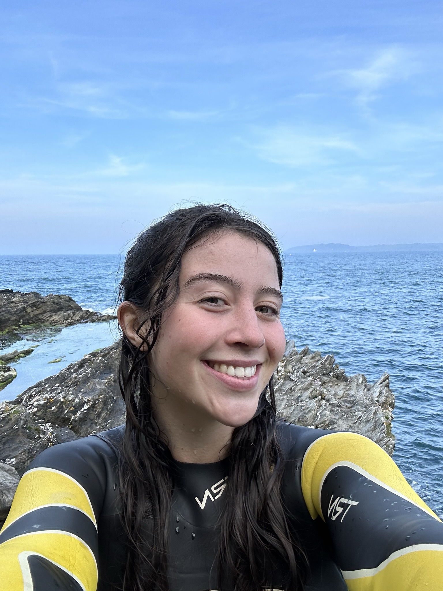 A photo of Purdy with the sea and rocks in the background